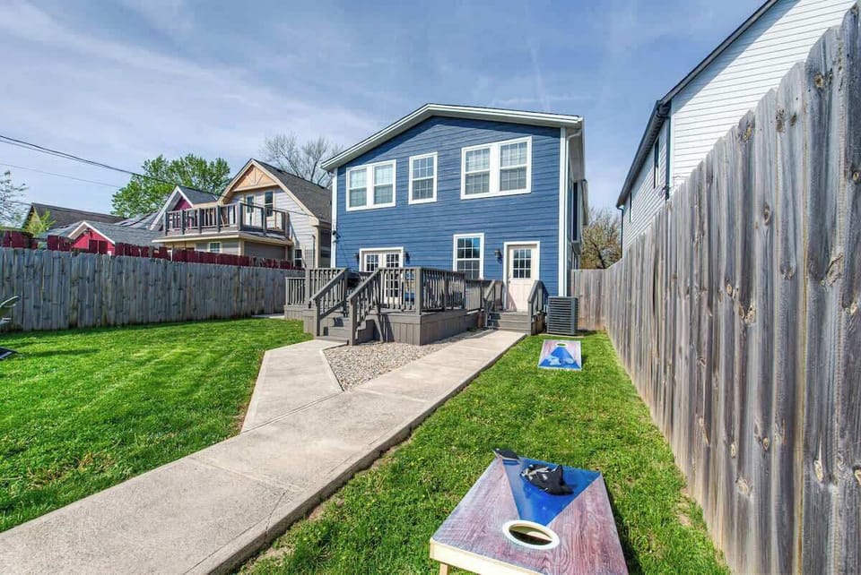 The backyard is an inviting retreat with a spacious deck and comfortable seating. Enjoy outdoor cooking on the grill, play cornhole, and gather around the fire pit for warm evenings under the stars. Perfect for relaxation and fun!