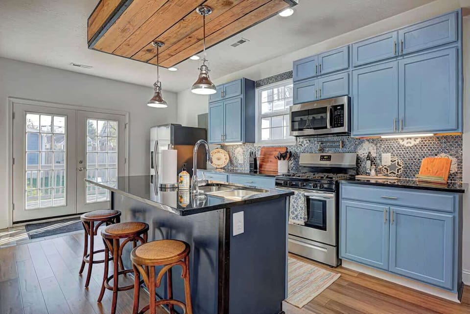 The fully equipped kitchen has everything you need, including cooking utensils, dishes, and cups. A coffee bar, complete with sugar and creamer, adds convenience, and the island seats 3 comfortably for dining or meal prep.