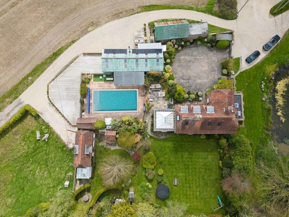 The home has a swimming pool, extensive gardens and patio space, a yoga studio next door and large driveway.