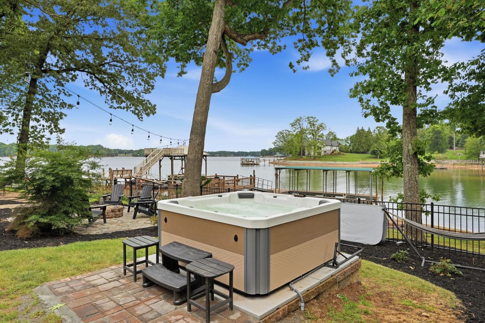 Soak in the private hot tub while overlooking peaceful lake views, towering trees, and your own waterfront escape.