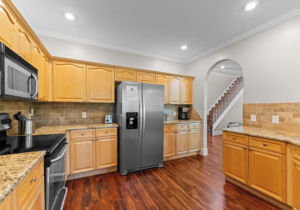 Open kitchen, providing lots of cooking counter space, with bar seating.