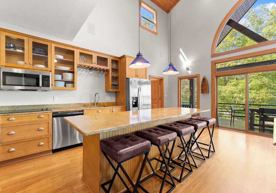 Large island for all to gather in the kitchen, off the living room. Bar stool seating for 6.