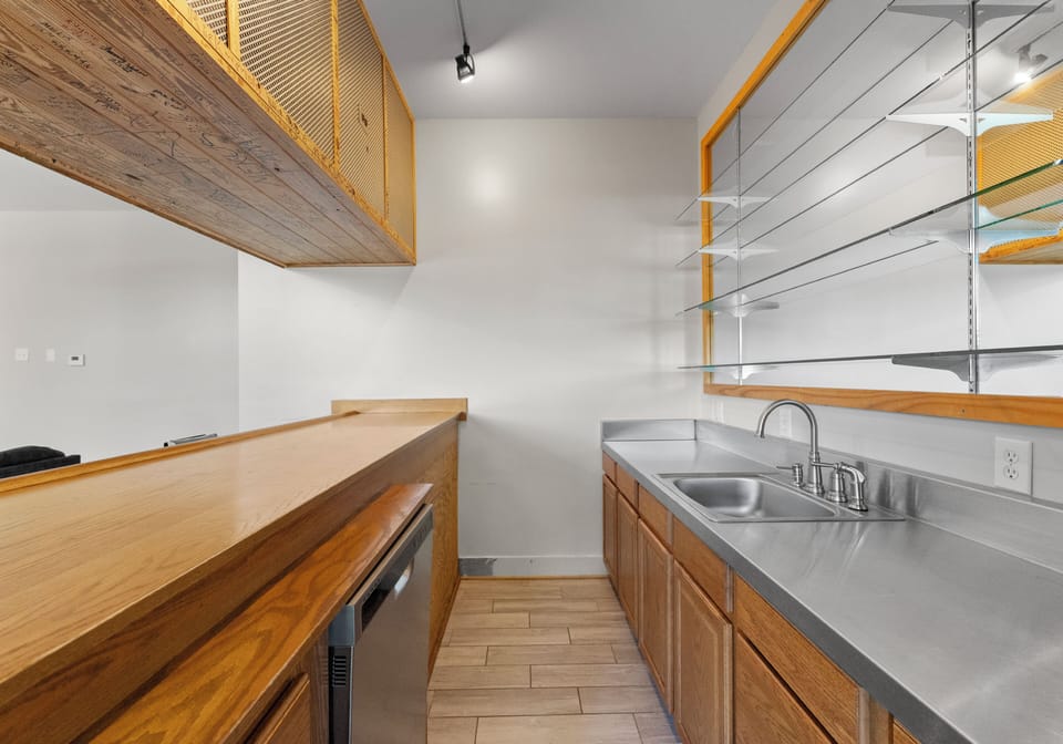 Bar area with sink, dishwasher and fridge!