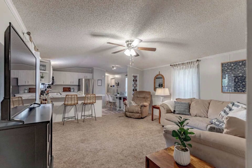 Living Room: Welcome to our cozy home featuring an open-layout living space with comfy seating and a well-equipped kitchen - perfect for relaxation or entertaining.