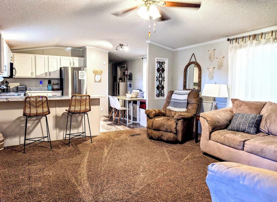 Living Room: Welcome to our cozy home featuring an open-layout living space with comfy seating and a well-equipped kitchen - perfect for relaxation or entertaining.