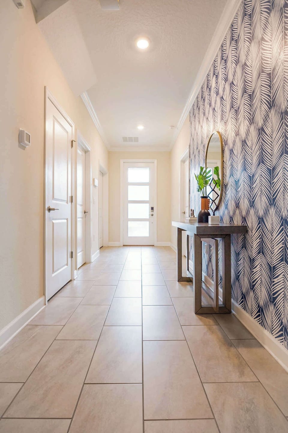 Stylish entryway with chic decor and modern lighting welcomes you to your luxurious retreat.
