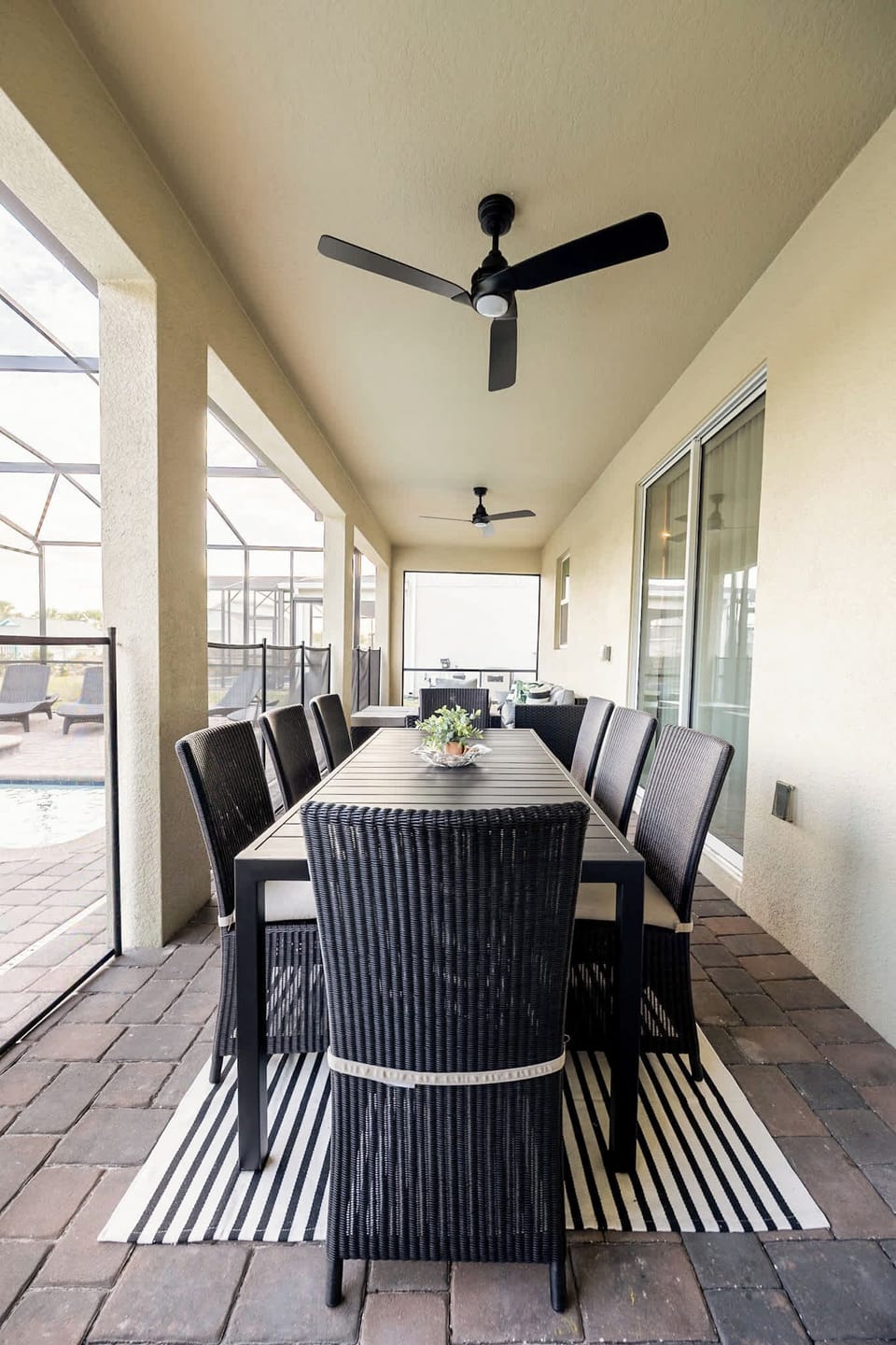 Spacious patio dining area perfect for gatherings, overlooking a private pool for a relaxing retreat.