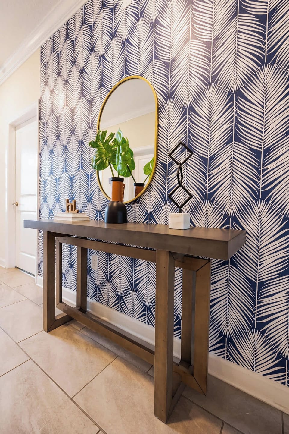 Stylish entryway with bold wallpaper and chic decor, setting the tone for a memorable stay.