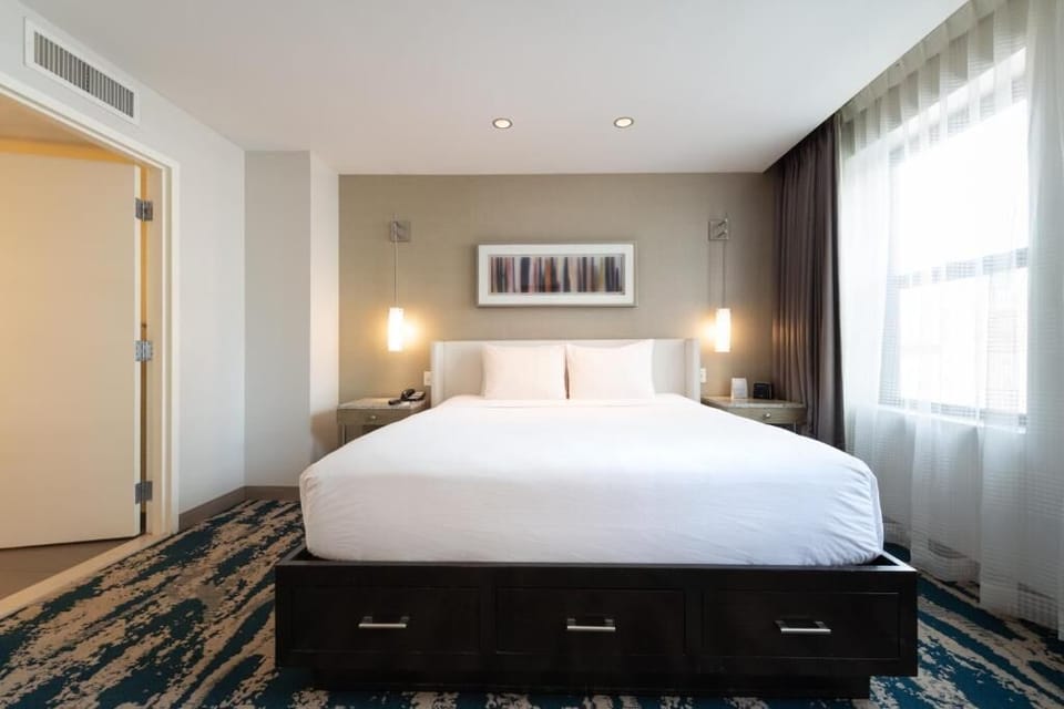Sink into a cloud-like king bed beneath warm lights.