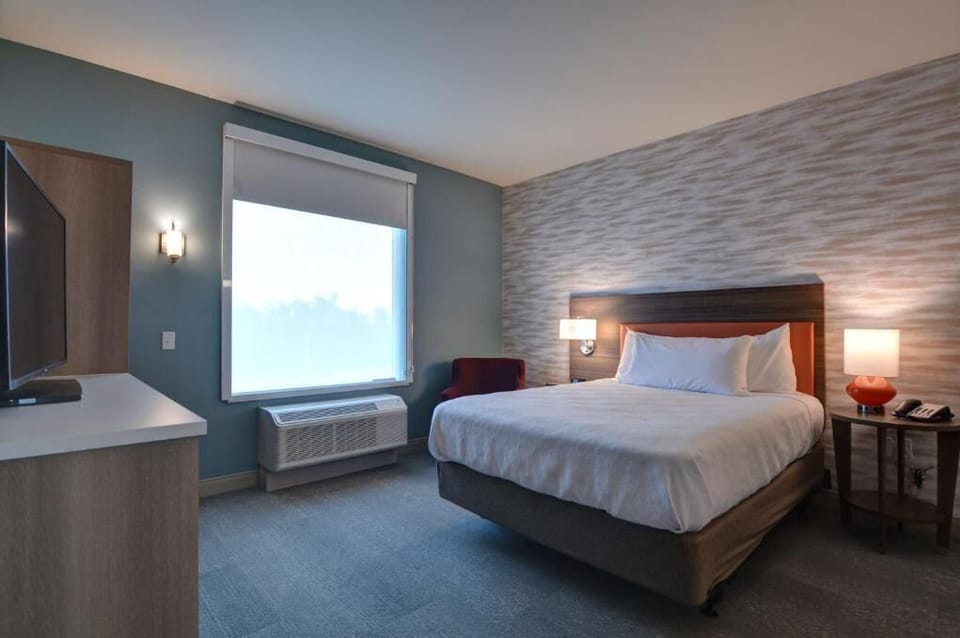 Unwind in a quiet room with soft lighting and comfort.