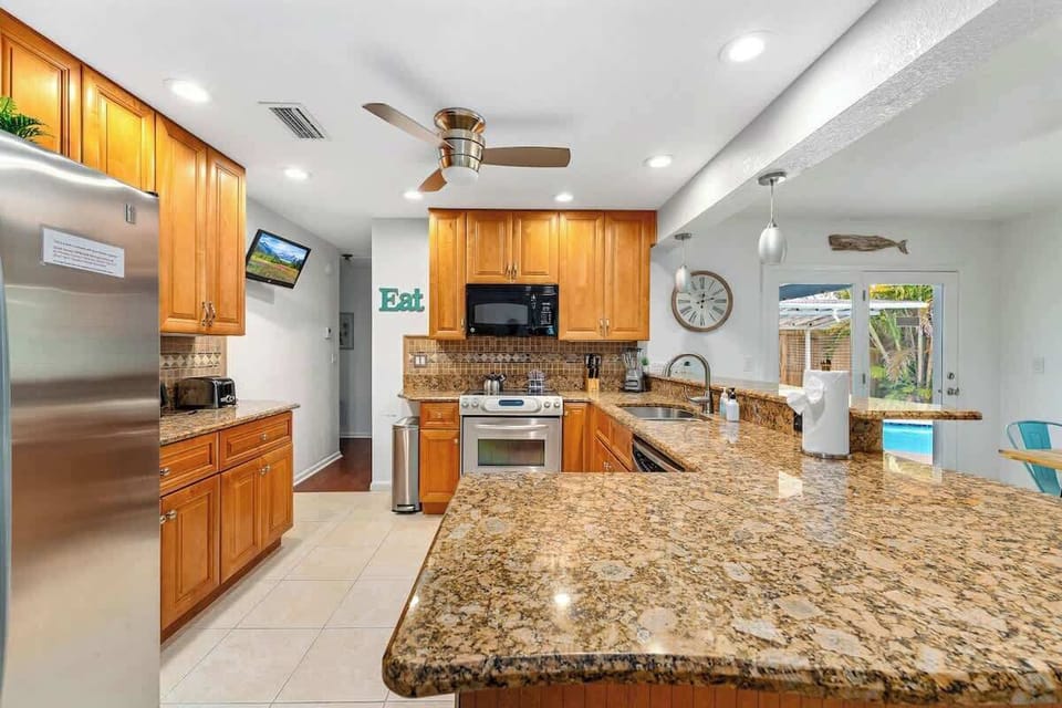 Bright, fully equipped kitchen made for easy cooking and gathering. Granite countertops, stainless steel appliances, and generous prep space create the perfect setting for family breakfasts, home-cooked dinners, and entertaining after day by the pool