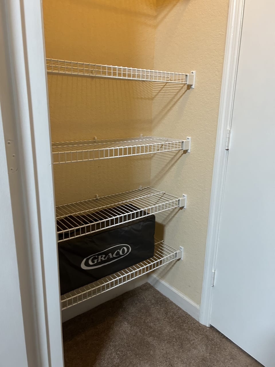 Portable Playpen for families with young children located in master room closet