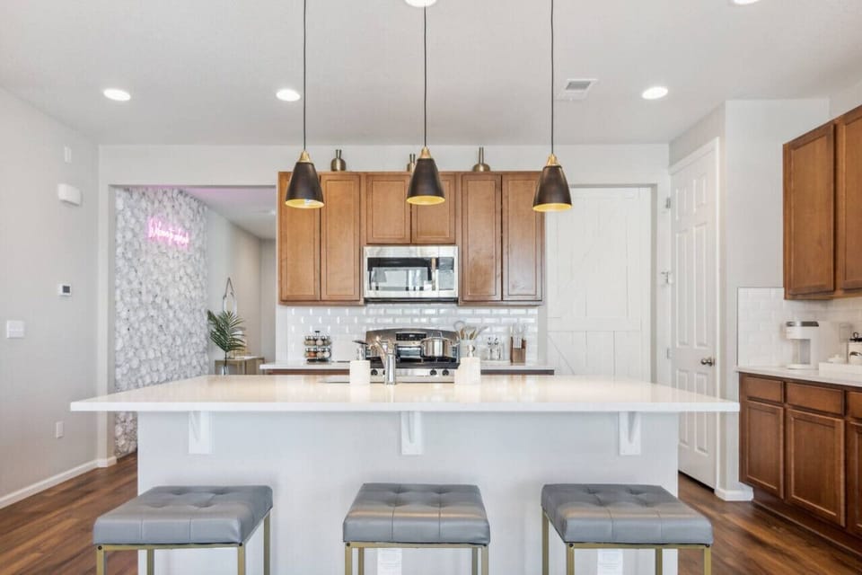 Crack open your laptop at the kitchen island while coffee brews – this space transitions from remote office to dinner party central faster than you can say `project deadline`