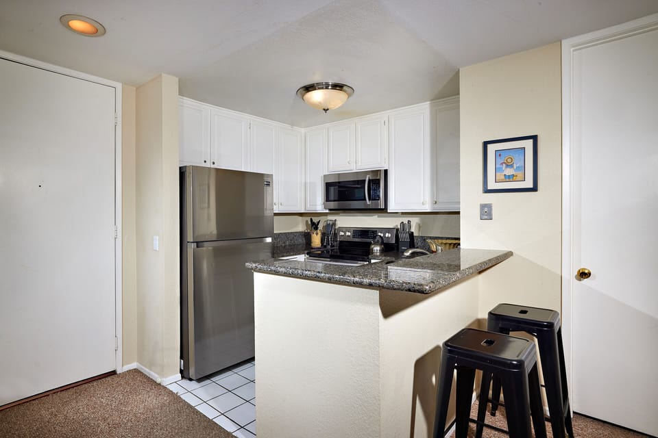 fully equipped kitchen with stainless steel appliances