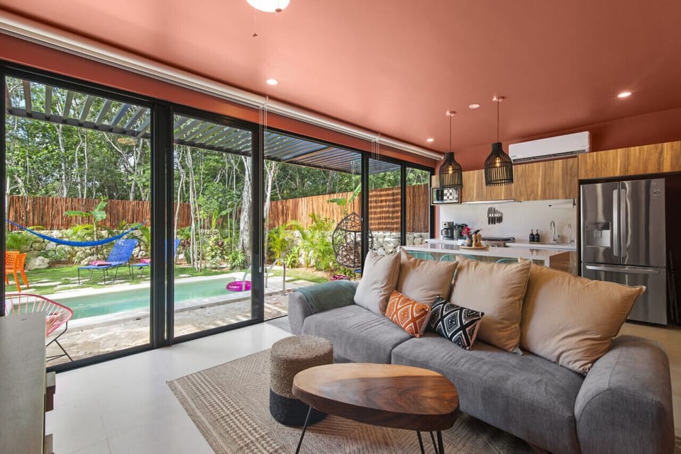 living area with tv, view of yard/pool, bbq, fast internet
