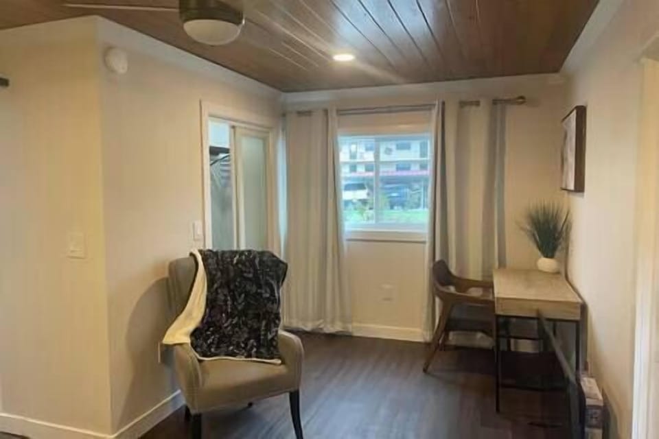 Bedroom has a new modern closet, a comfy chair, and an office set. 