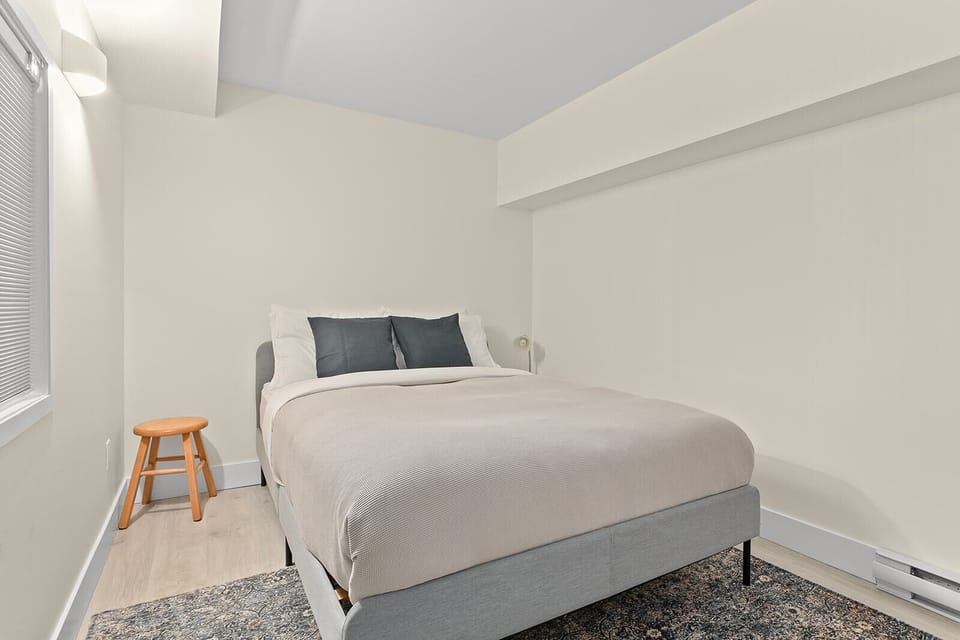 Queen sized bed in walkout basement bedroom.