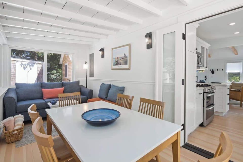 The converted porch has plenty of natural light with easy kitchen access