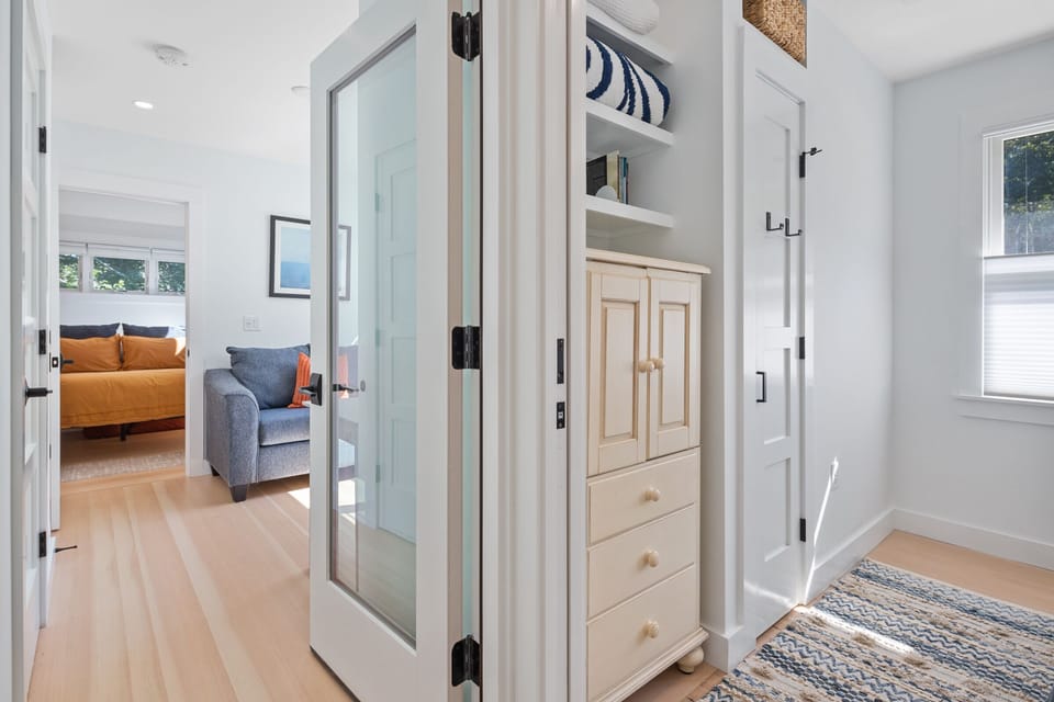 The hallway leads you towards the office nook and primary suite