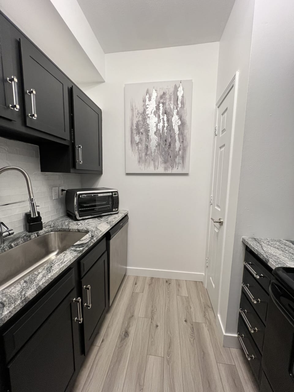 Fully stocked galley kitchen with large pantry off the main open living space. 