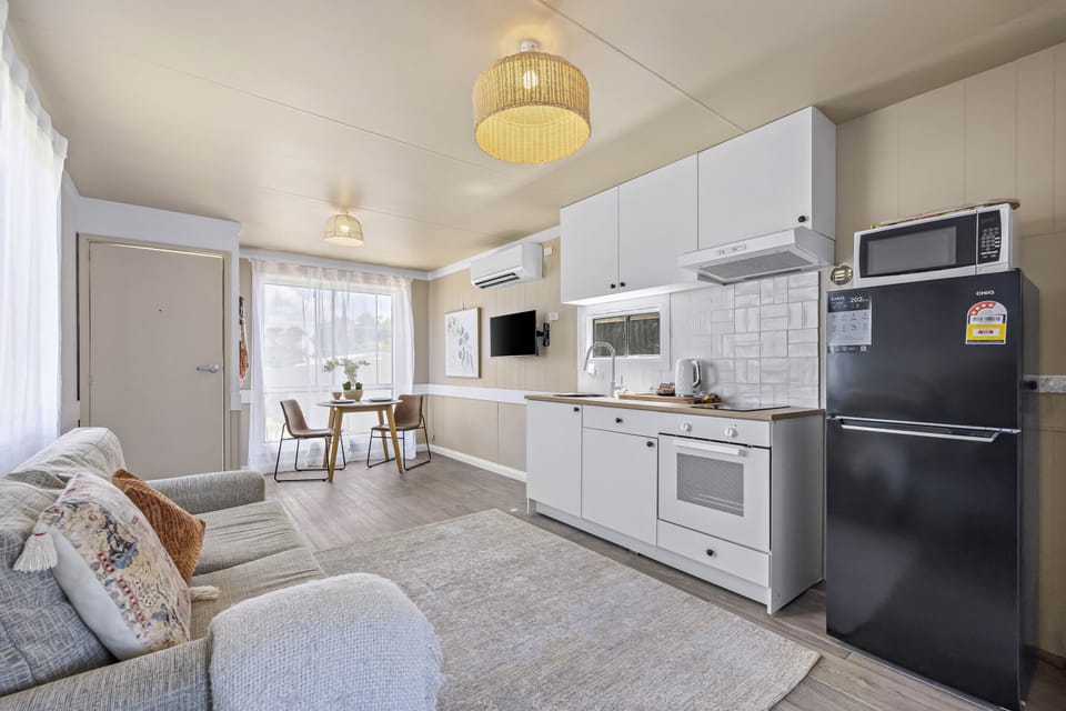 Living area with fully equipped kitchen and dining space.