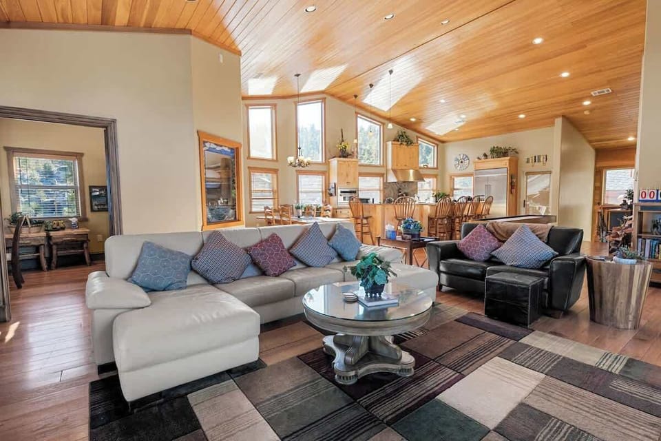 Main Living area- Upper level. Large couch, love seat, gaming table, 65" smart tv, gas fireplace, and shuffle board. Open to dining area,  kitchen, office/room5, and upper decks! (new couches were added, pics coming soon!