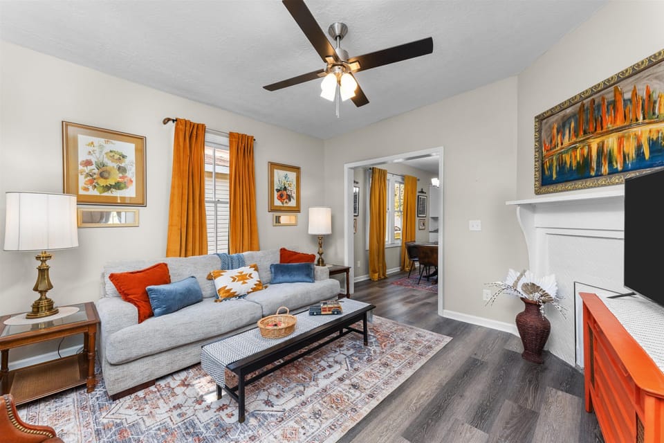Comfortable living area with smart TV and ceiling fan.