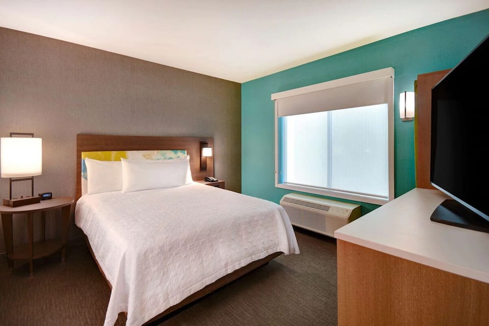 Unwind in a serene bedroom with soft lighting and calm tones.