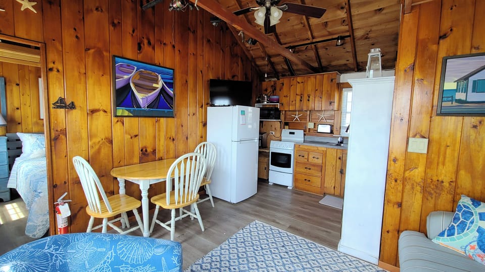 Main living area has a sofa, chair and dining table