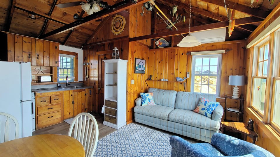 Main living area has a sofa, chair and dining table