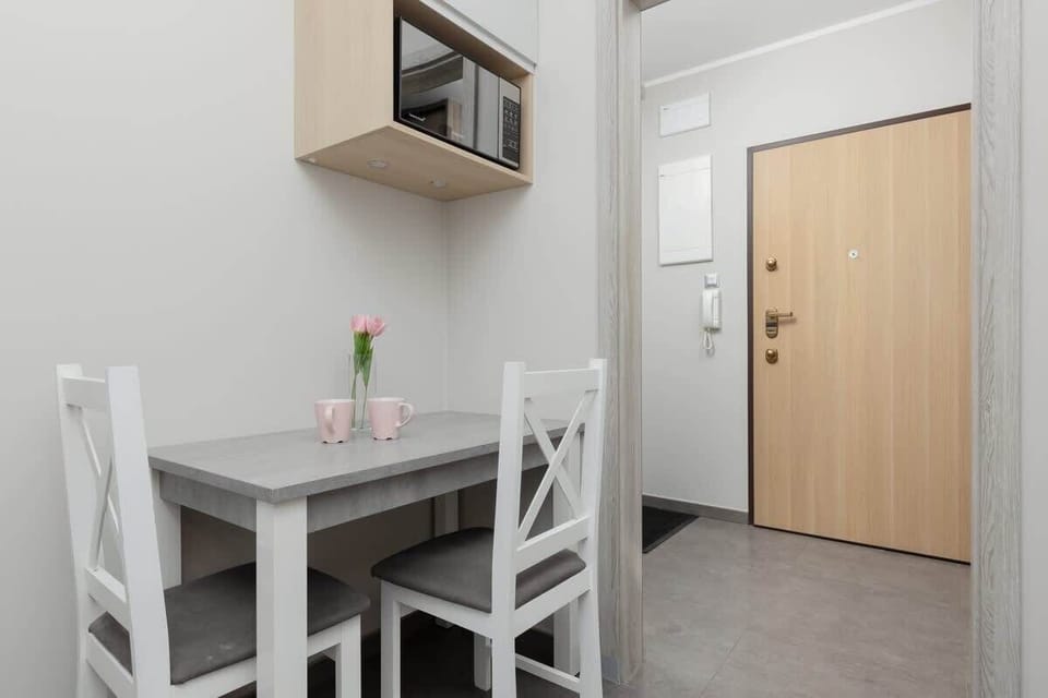 A small dining corner with a table and chairs, placed near the kitchen.
