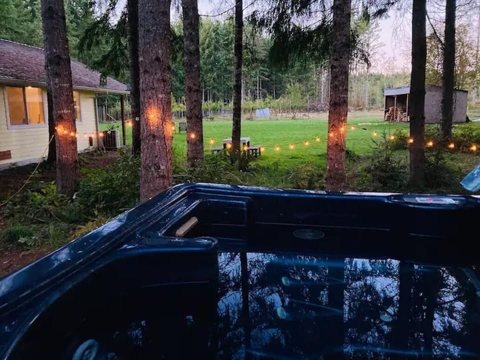 Hot soak under the trees with an orchard view