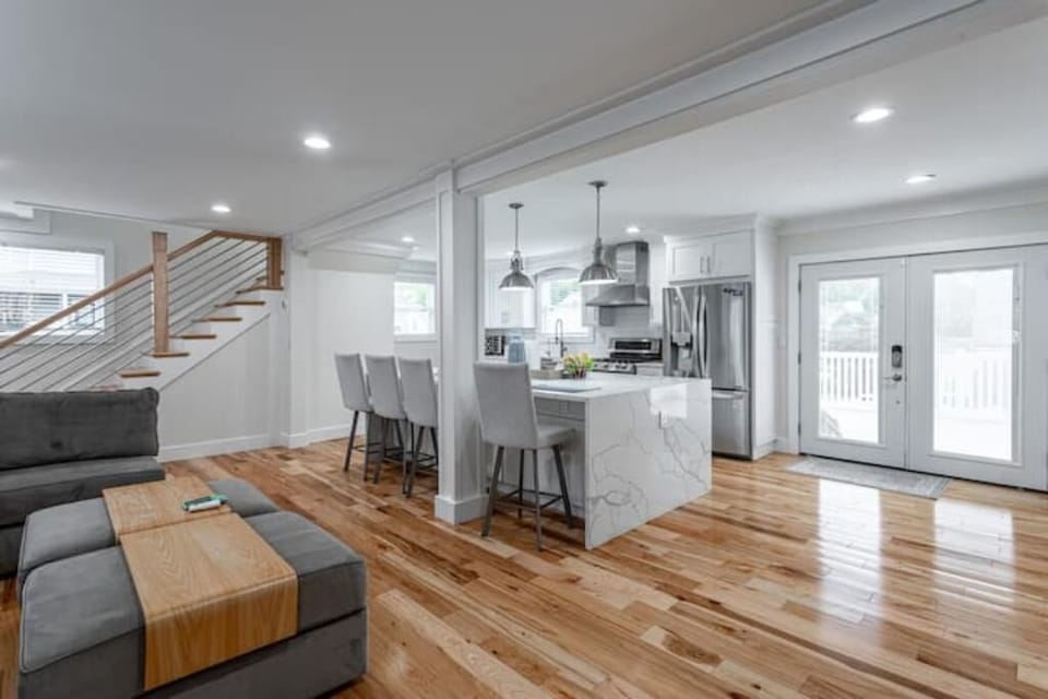 The outdoors beckons with large glass doors that step out onto the deck 