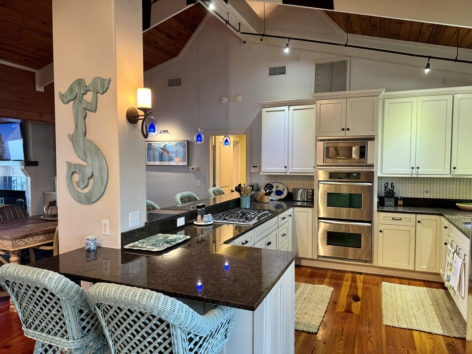 Five stools around kitchen bar. Fully equipped and has a gas grill outside door.