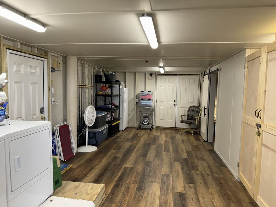 Laundry, tiki bar, bunk room, bathroom entrance with beach accessories & fridge