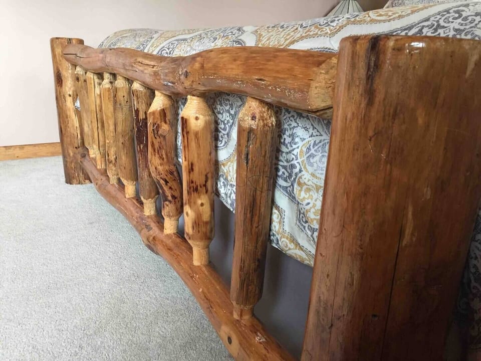 Log bed frame in the King bedroom