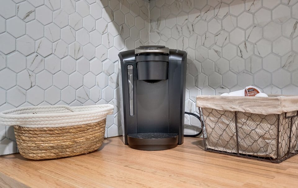 Coffee bar with K-Cups, Truvia, sugar, and mini creamers.