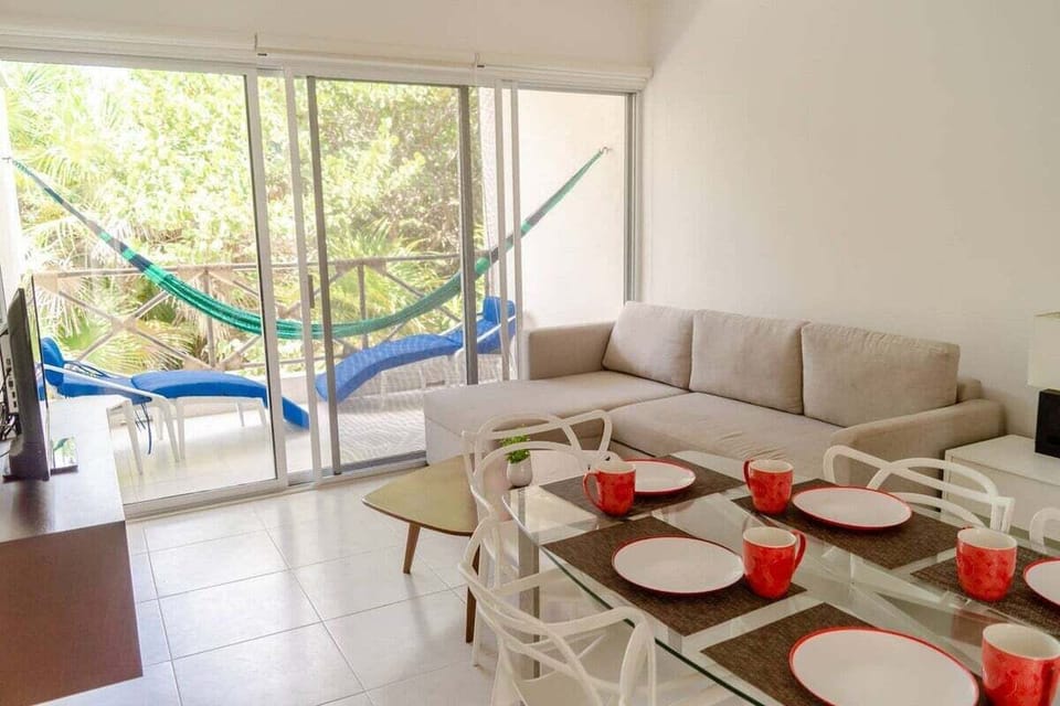 The living room has a large terrace with comfy outdoor furniture