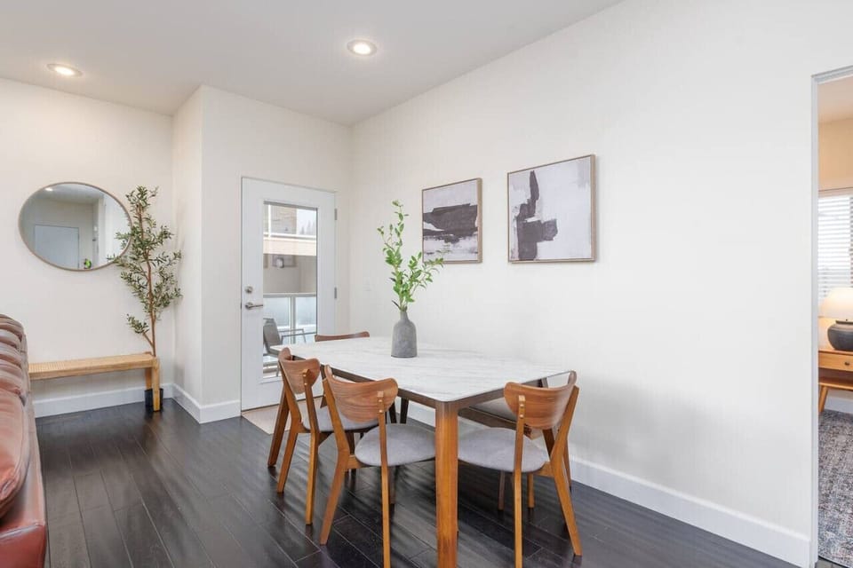 The dining area features a stylish table with seating for six, perfect for enjoying meals and gathering