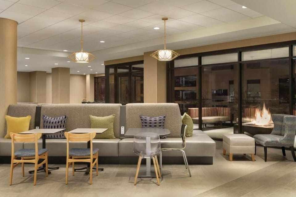 Unwind by the glowing fire with cozy seating and calm vibes.