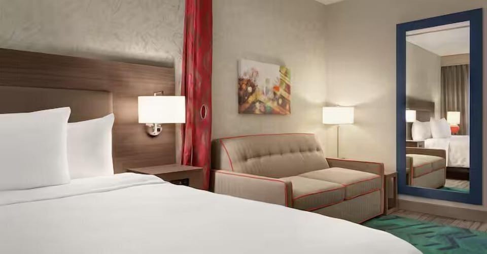Lounge comfortably after sightseeing with sofa seating beside the bed.