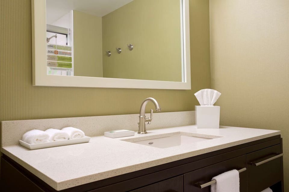 Refresh at a spotless vanity with fresh towels ready.