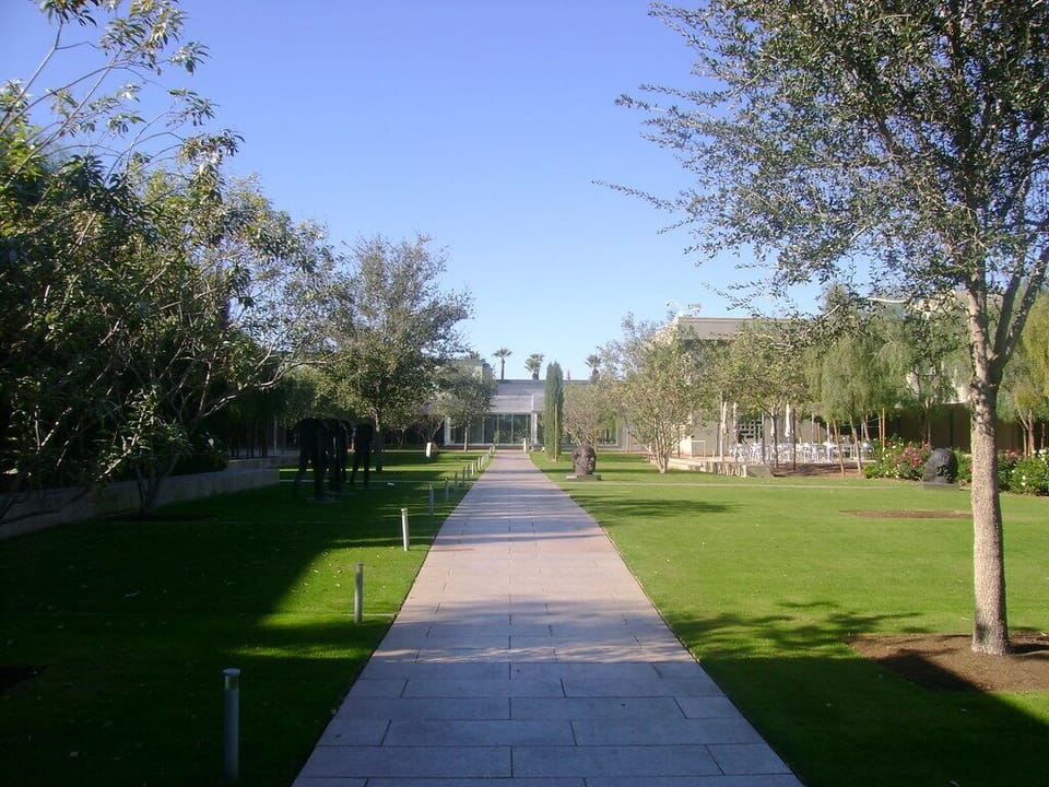 Unwind with a peaceful stroll through lush, sunlit walkways nearby.