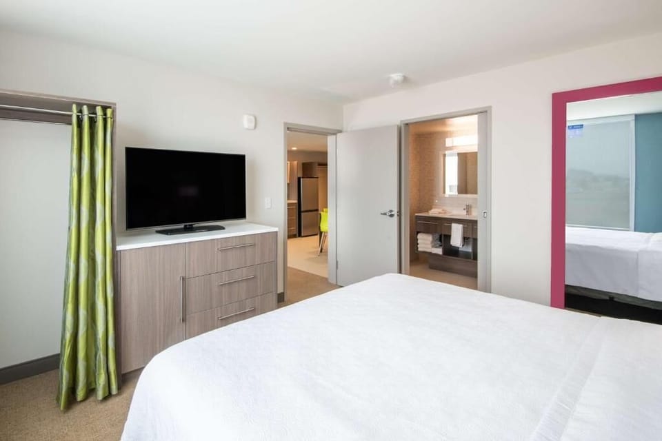 Unwind in a crisp bedroom with TV and easy ensuite access.