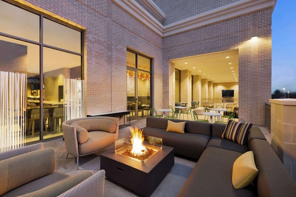Unwind by the glowing fire pit under evening lights.