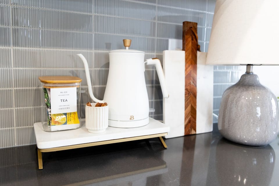 Tea time perfection! Our modern gooseneck electric kettle boils water quickly for the perfect cup. Explore a variety of provided teas and savor a delightful moment in just minutes. 