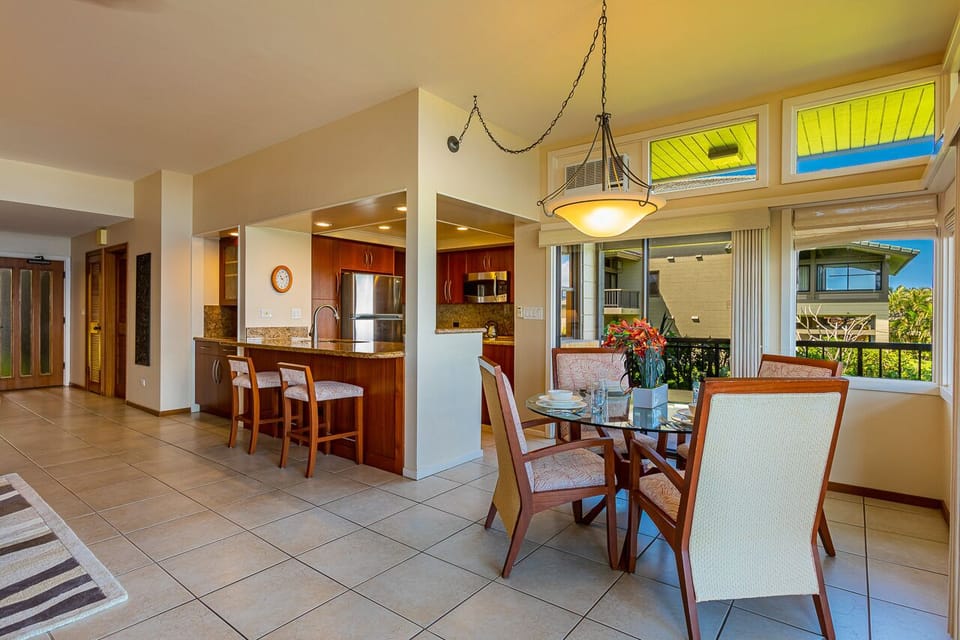 Sunlight pours through skylights and windows, brightening your open dining and kitchen space where you'll share meals and make memories in tropical comfort.