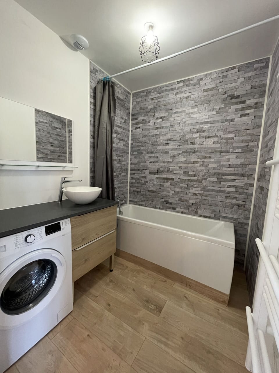 "Modern bathroom with bath, mirror and heating"