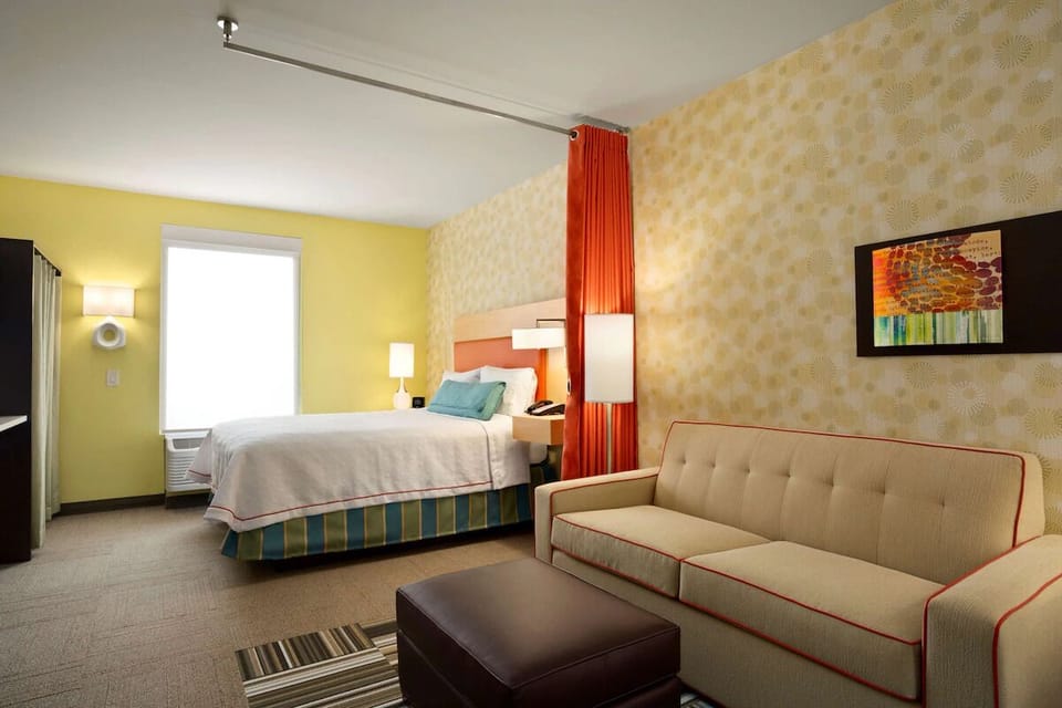 Unwind in a bright suite with cozy sofa seating.