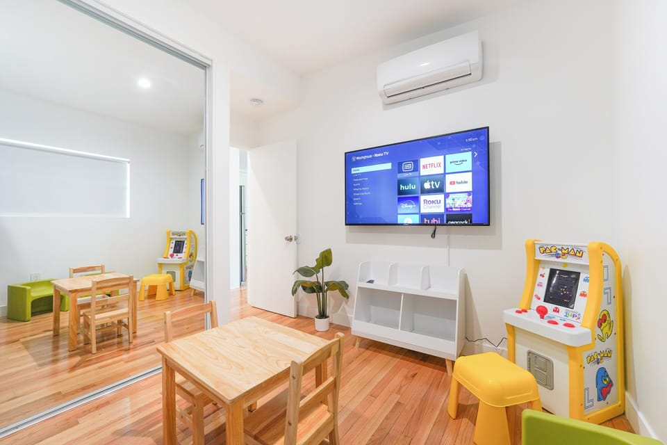 Kids room has small arcade game and 4K TV